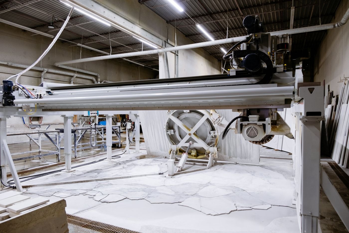 A granite-cutting machine illustrates industrial processing equipment.