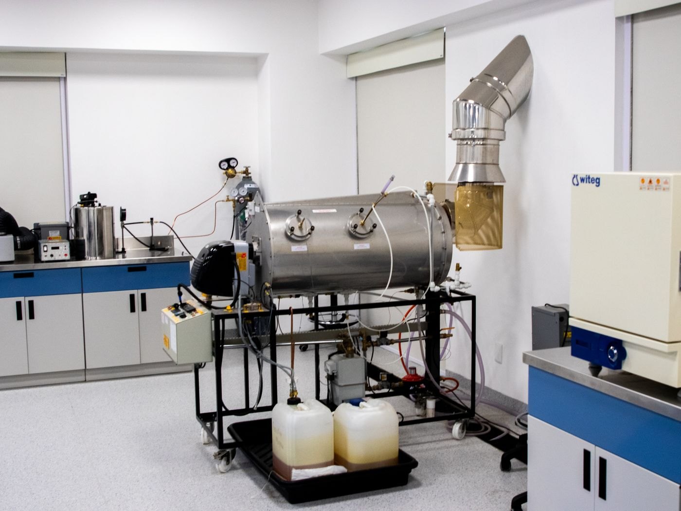 An equipment-filled laboratory illustrates a technical working environment.