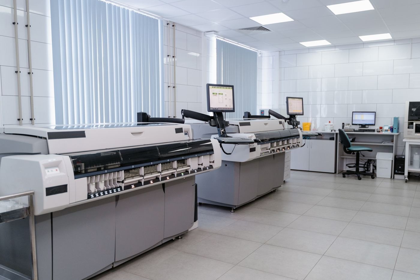 Technical workstations and equipment illustrate laboratory infrastructure.